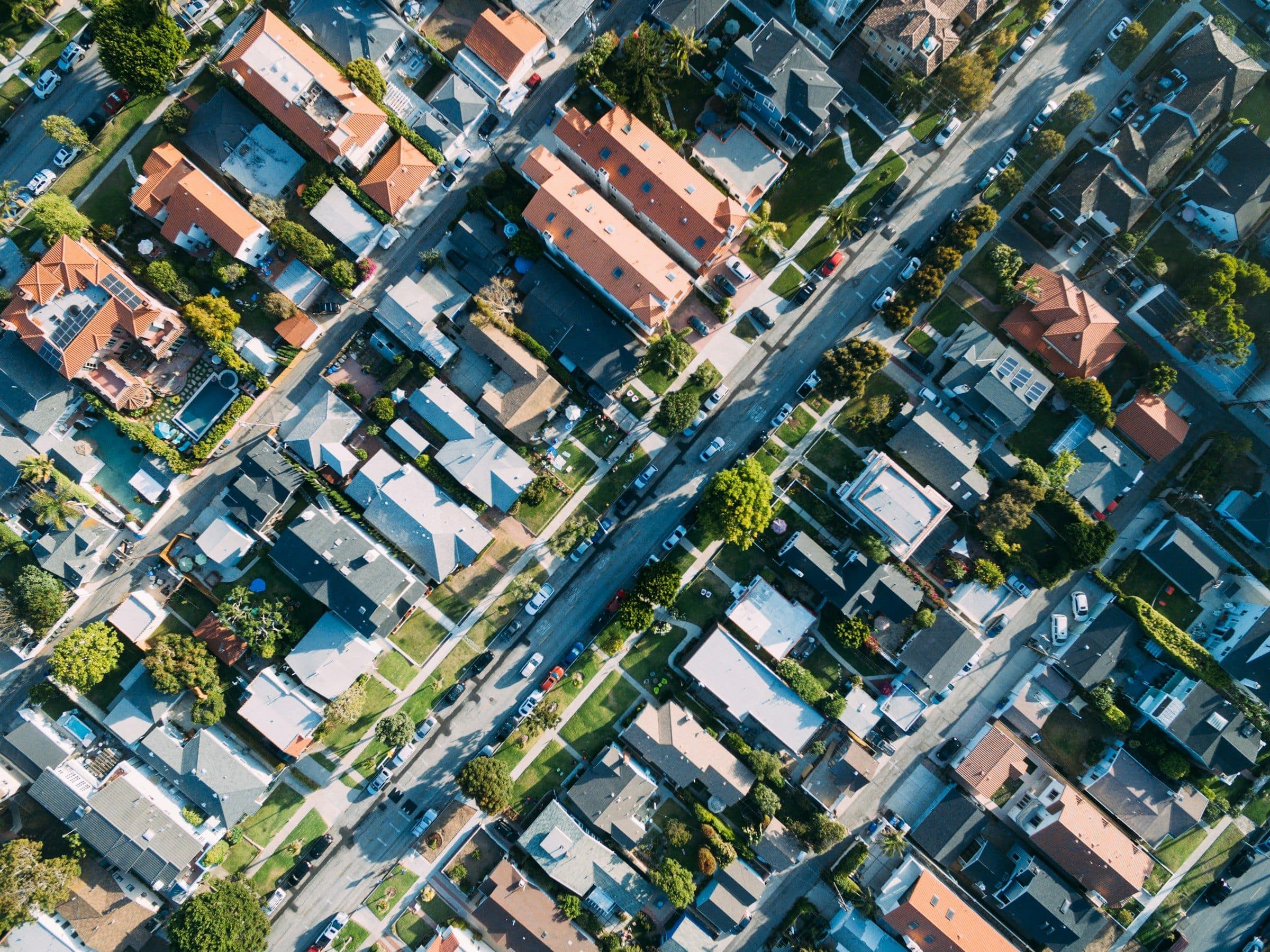 Aerial view of a residential neighbourhood grid with tree-lined streets